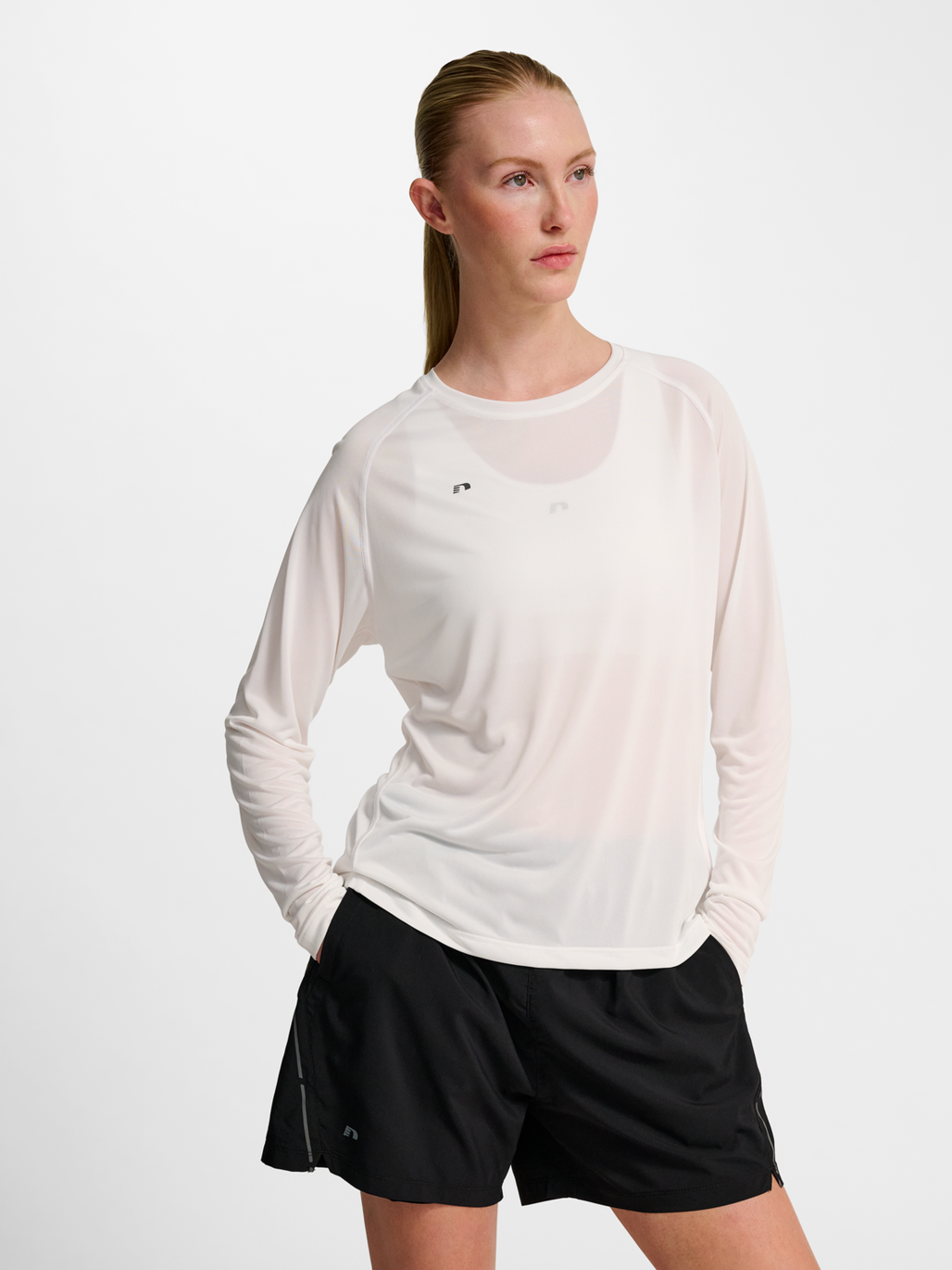 Women's white long-sleeve running shirt, front view on model