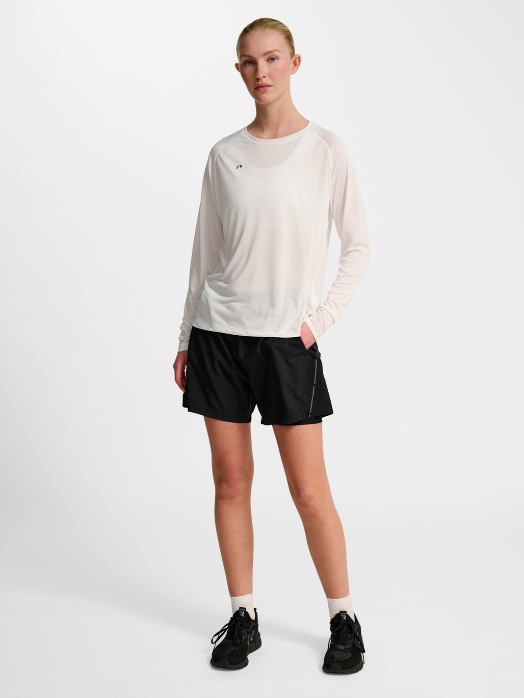 Women's white long-sleeve running shirt, back view on model