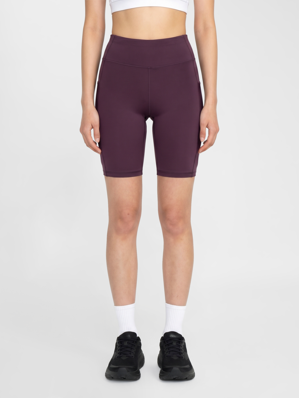 Women's plum high-waist short running tights, front view on model