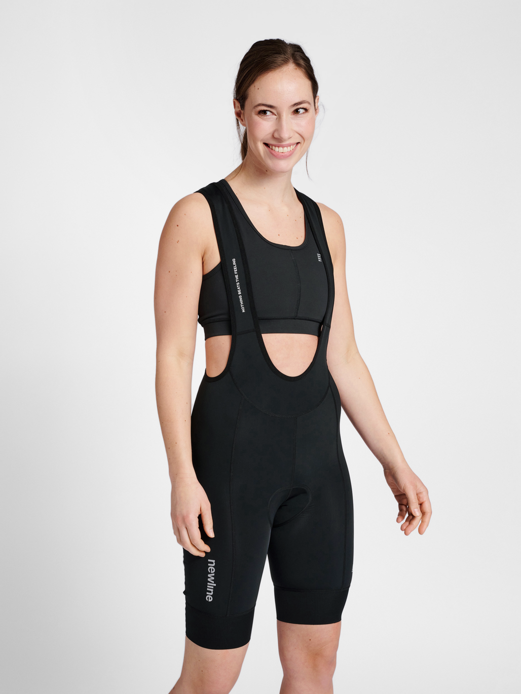 Women's black cycling bib shorts, front view on model