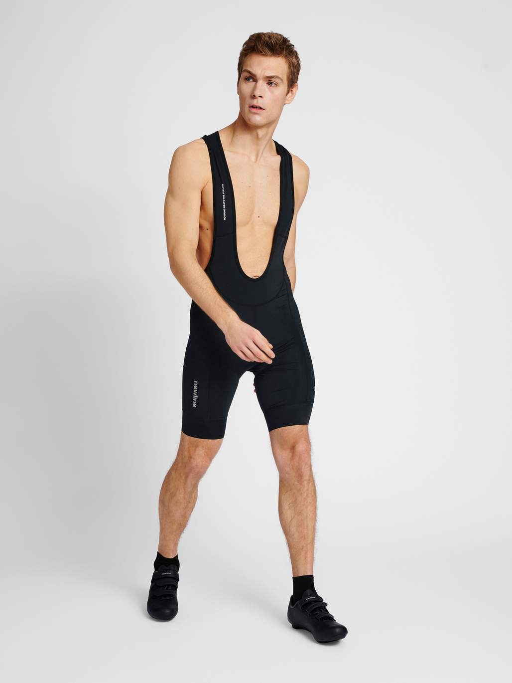 Men's cycling bib shorts in black, back view with mesh panel
