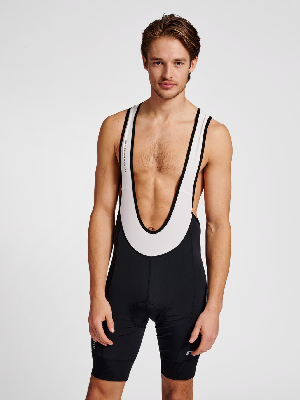 Men's cycling bib shorts in black/white, front view on model