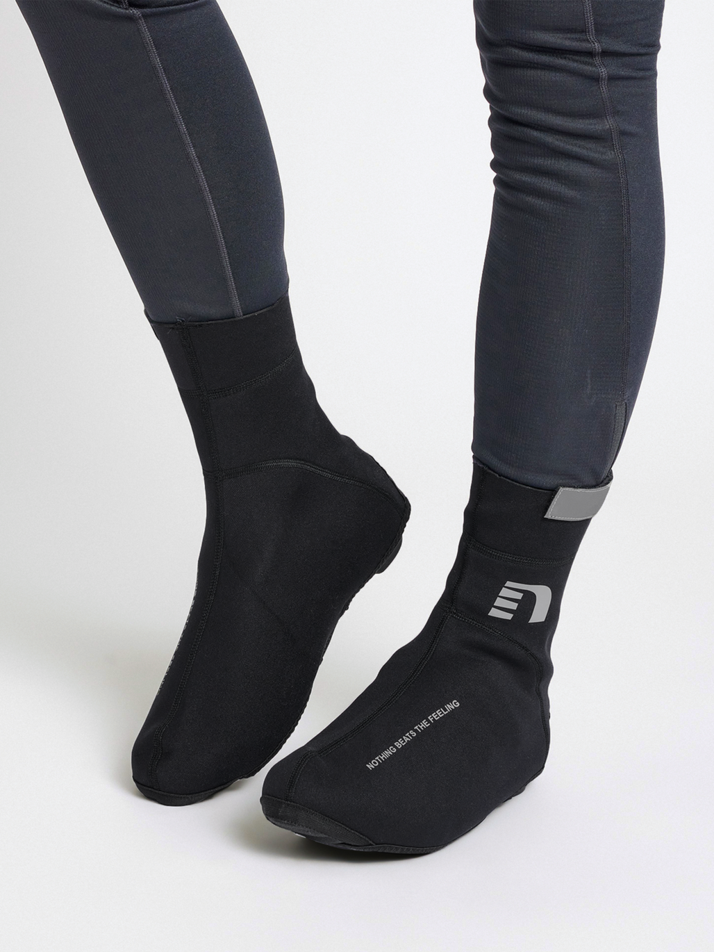 Black thermal cycling shoe covers, on model