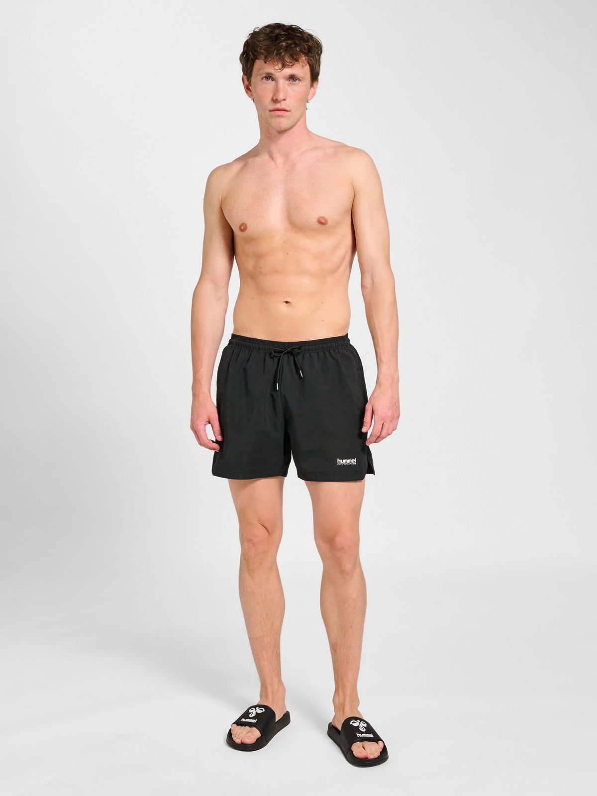 Men's black swim shorts, side view on model