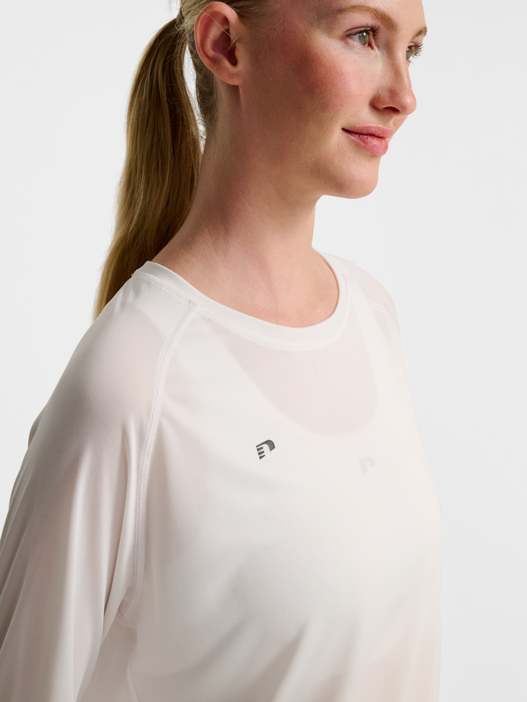 Women's white long-sleeve running shirt, detail on model