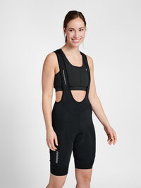 Women's black cycling bib shorts, front view on model