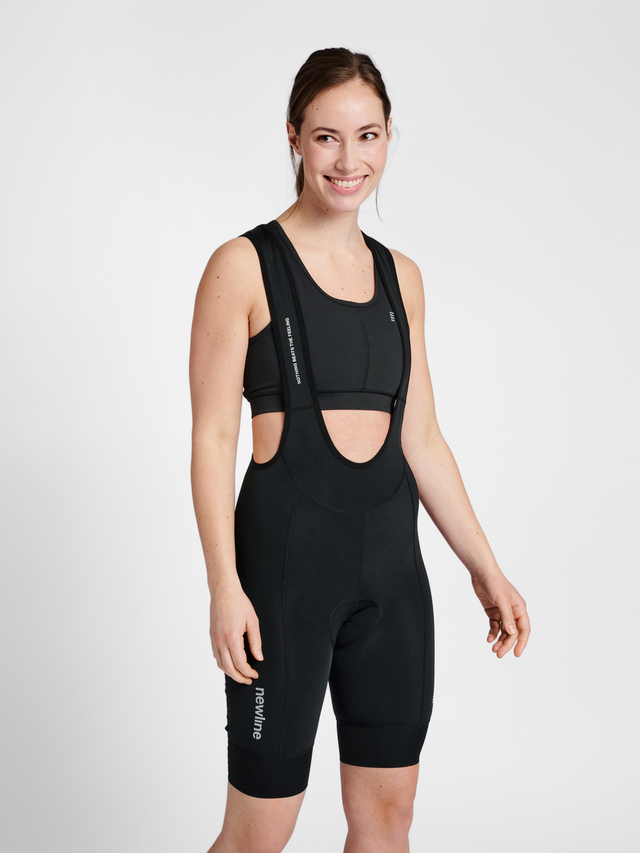 Women's black cycling bib shorts, front view on model