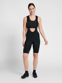 Women's black cycling bib shorts, back view on model