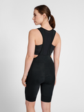 Women's black cycling bib shorts, side view on model