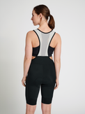 Women's black/white cycling bib shorts, side view on model