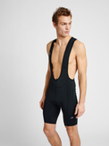 Men's cycling bib shorts in black, front view on model