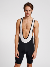 Men's cycling bib shorts in black/white, front view on model