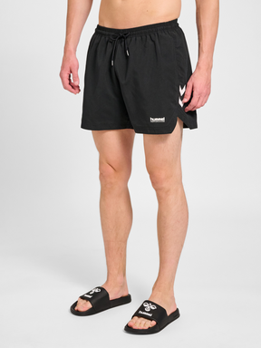 Men's black swim shorts, front view on model
