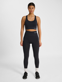 Women's black seamless high-waist tights, side view on model