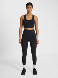 Women's black seamless high-waist tights, side view on model