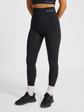 Women's black seamless high-waist tights, front view on model