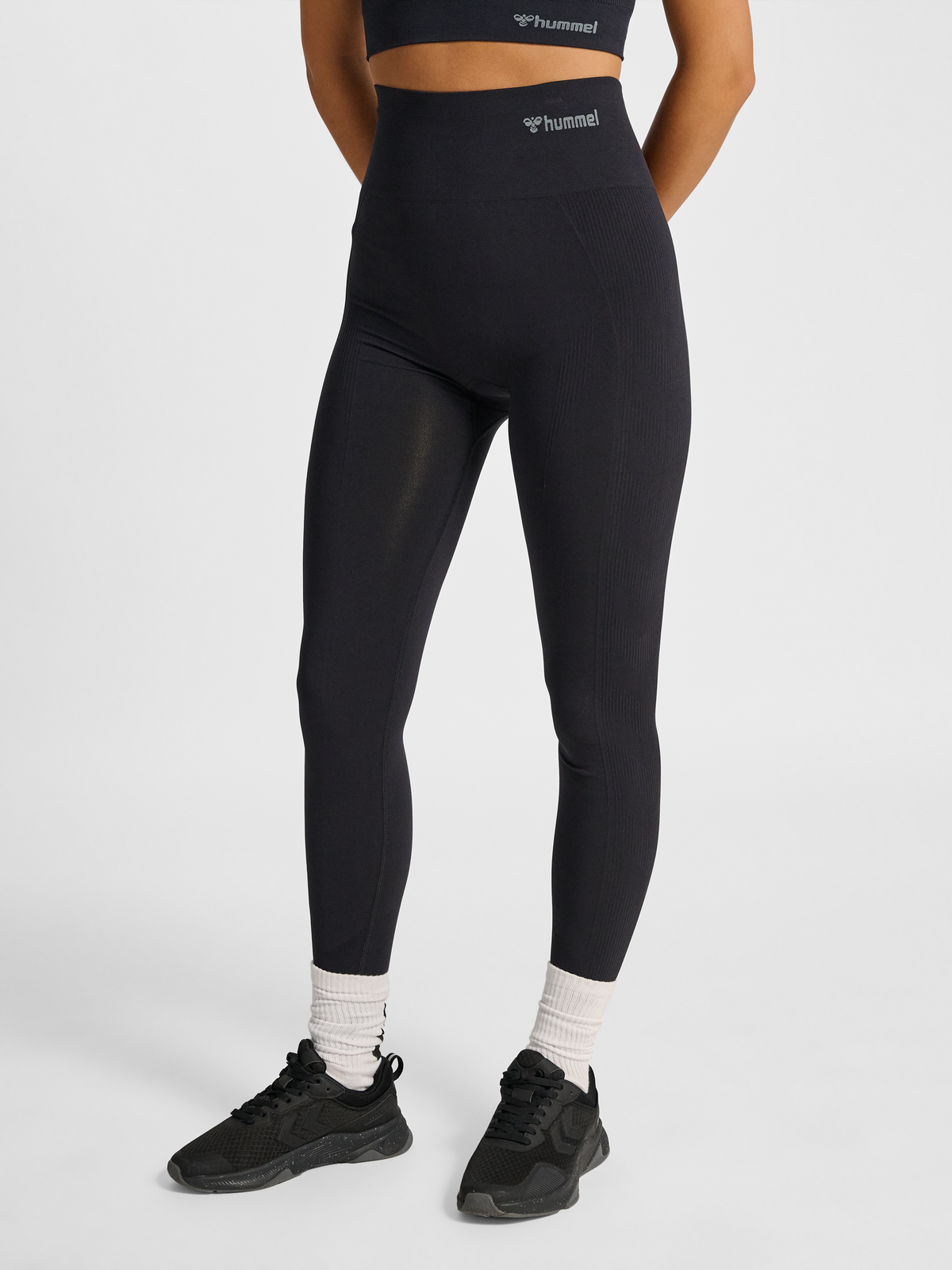 Women's black seamless high-waist tights, front view on model