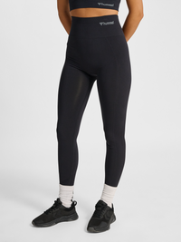 Women's black seamless high-waist tights, front view on model