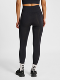 Women's black seamless high-waist tights, back view on model
